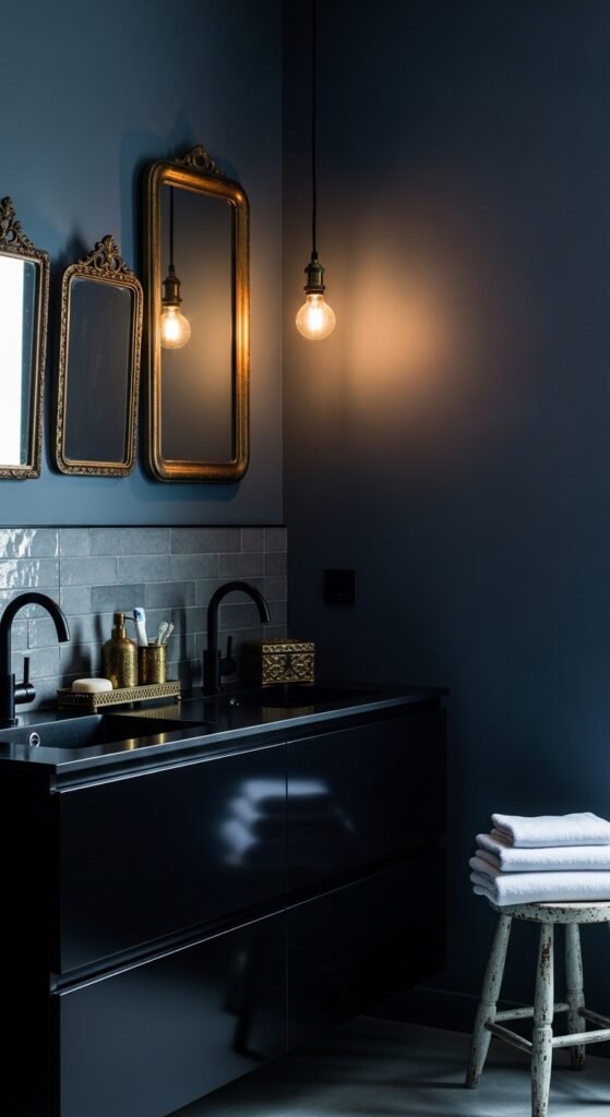 A beautifully transformed moody bathroom featuring dark walls, black tile, warm layered lighting, gold brass fixtures, freestanding tub, and lush plants, showcasing 20 moody bathroom ideas to create a dramatic and luxurious sanctuary at home.