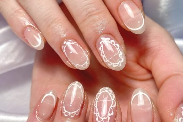Close-up of stunning black lace nail designs showcasing a variety of edgy and romantic manicure styles including matte black glossy lace, sheer nude lace overlay, burgundy gradient, silver filigree, and gold lace on deep black base, perfect inspiration for bold and chic black lace nail art