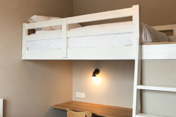 A beautifully styled small bedroom transformed into a cozy and functional haven using clever space-saving furniture, floating shelves, soft neutral tones, and smart minimalist decor ideas for tiny spaces.