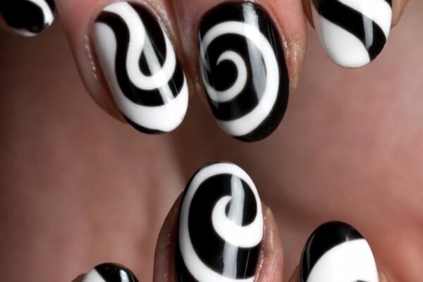 A close-up of beautifully painted swirl nail art designs showcasing classic black and white swirls, pastel rainbow blends, metallic gold and burgundy patterns, and ocean blue waves across short well-groomed nails — the ultimate swirl nail art inspiration for mesmerizing and easy-to-wear creative manicures.