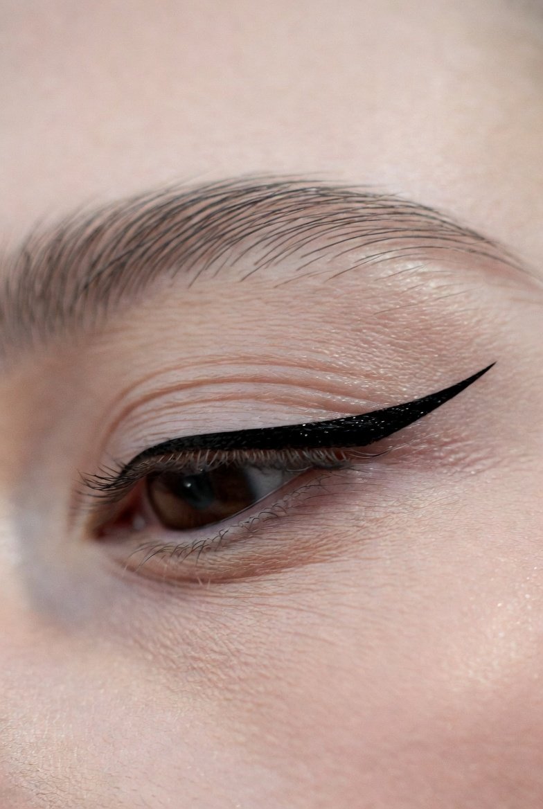 Alt Text: Close-up beauty photographs of Metallic Foil Eyeliner, Siren Eyes, and Dot Liner Accent showcasing glamorous reflective festive elongated seductive and whimsical minimal eyeliner styles that boost confidence and unleash your inner makeup artist.